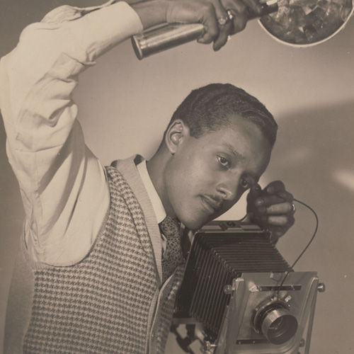 Photographic print of Robert Scurlock holding a camera