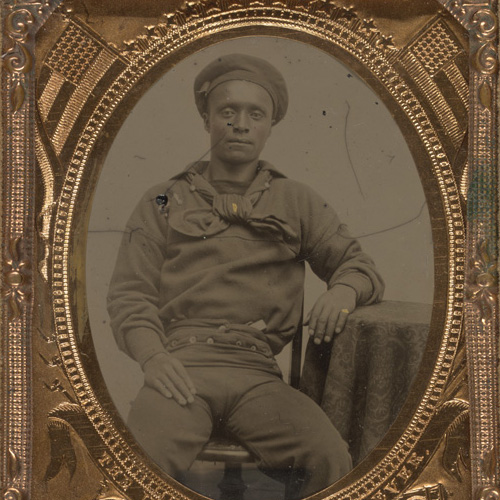 Tintype photograph of unidentified African American sailor in Union uniform sitting with arm resting on table