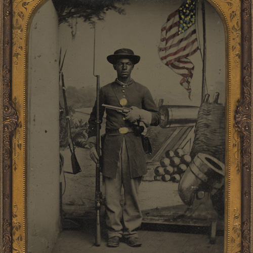Tintype photograph of unidentified African American Union soldier with a rifle and revolver, Benton Barracks, Saint Louis, Missouri
